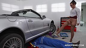 Wendy pleasures in a man in an oil-stained uniform fixing his car in a garage