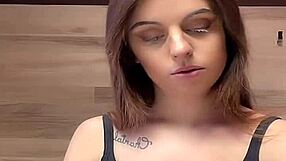 Woman with big boobs is shown in a tank top