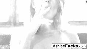 Busty redhead, Ashlee Graham, smokes and enjoys her natural assets