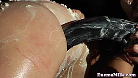 Three persons proceed to an enema and an anal sex toy play with a big toy