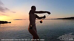 beautiful glamour model rehearsing fire show on the editorial photoshoot shoot on the seashore