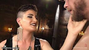 A woman forces a man to gag with a dildo