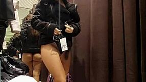 A beautiful girl lavishes herself in a shadowy pleasure in the fitting room