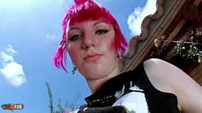In A stunning redhead punk undresses on the balcony