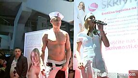 Amateur nurse strips and gives blow job on stage at sex event