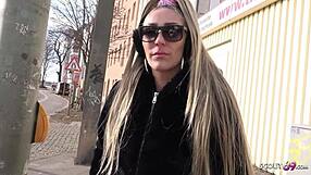 A blonde bartender from Berlin strips and gets double penetration in a rather kinky scene.