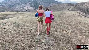 Young men seduce two girls in the mountains and have sex with them outdoors.