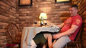 Beautiful girl gives a blow job in a cafe under the table