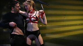 Submissive in leather bondage enjoys rough oral sex and slaps to the genitals