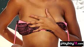 A black beauty in a bikini stripping outside by the pool
