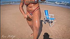 Tanned beauty in micro bikini gets it wet outdoors