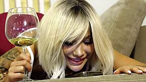 Blonde business woman enjoys wine and big toys alone