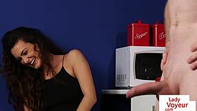 A beautiful woman opens her legs to help a man to masturbate in the kitchen