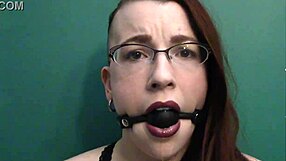 Redhead gets dirty with ball gag and lipstick