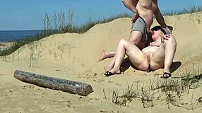 A man helps a blonde beauty with her curves on the beach