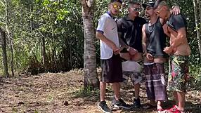 Muscular men in BDSM action in the woods with friends