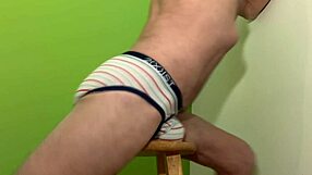 Male pelvic floor stretching on a stool in briefs